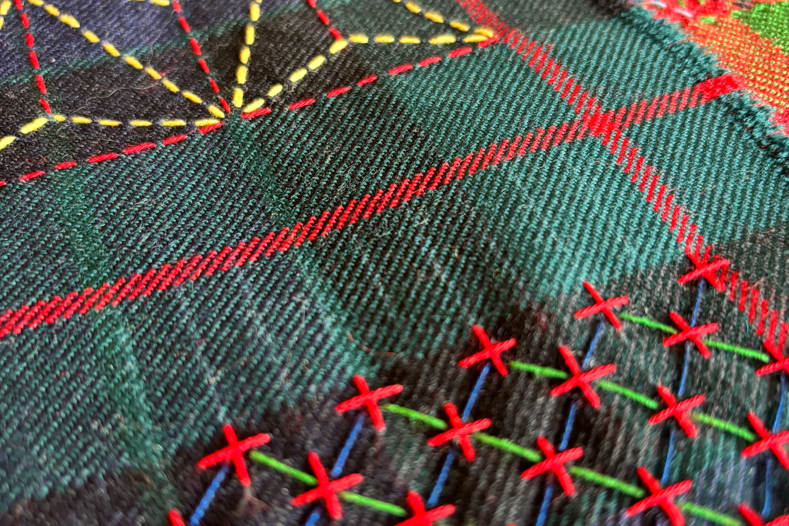 Decorative and colourful stitching sample on a kilt fabric.