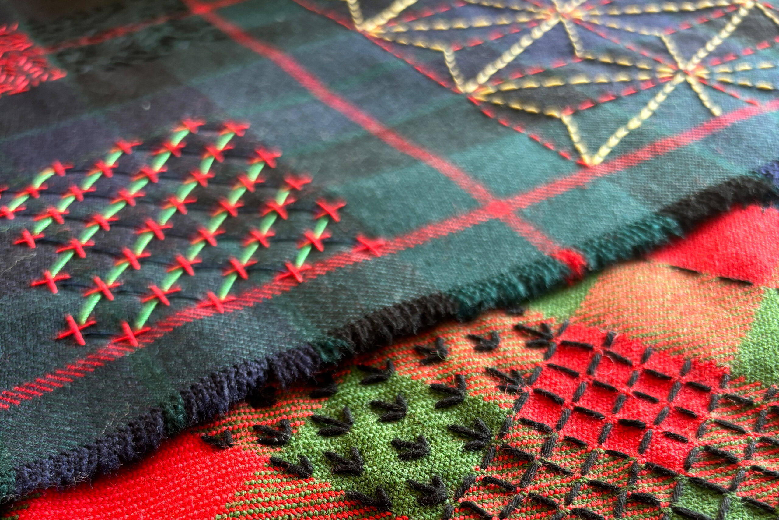 Decorative and colourful stitching sample on a kilt fabric.