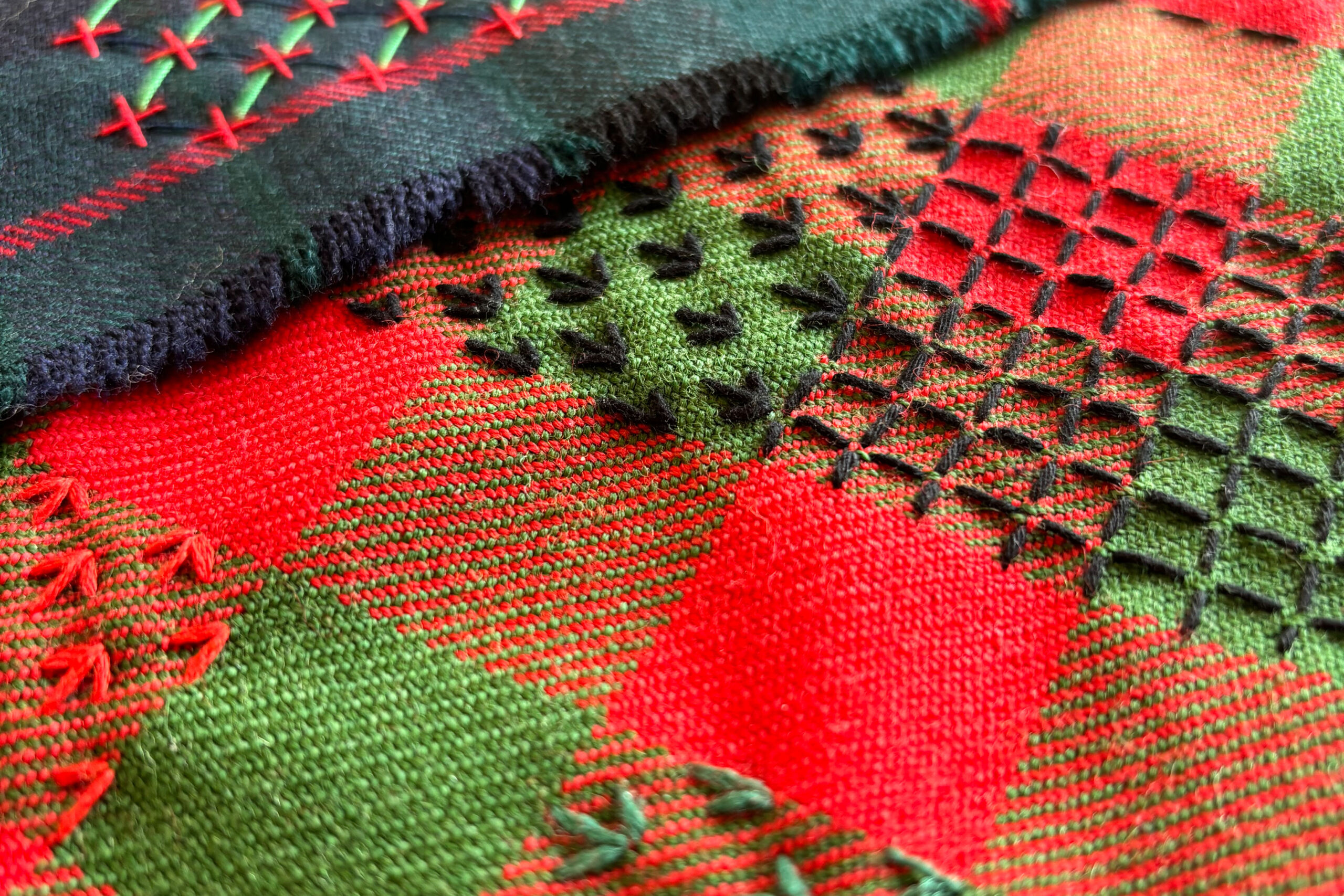 Decorative and colourful stitching sample on a kilt fabric.