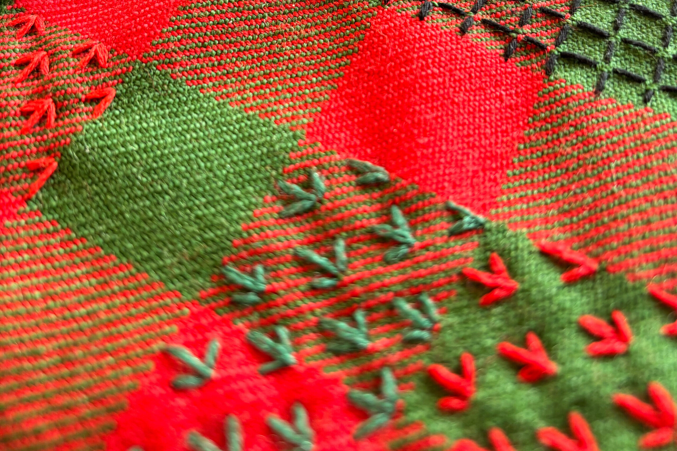 Decorative and colourful stitching sample on a kilt fabric.